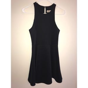 • Tiny black party dress w/a cinched waist •